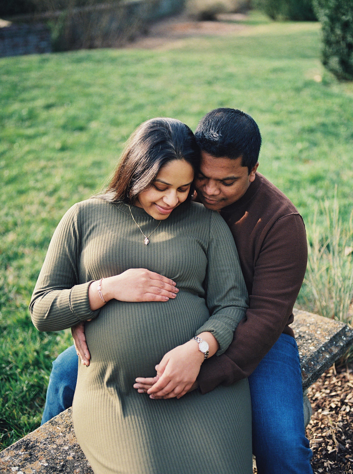 Loving couple embracing outdoors, highlighting the beauty of pregnancy.