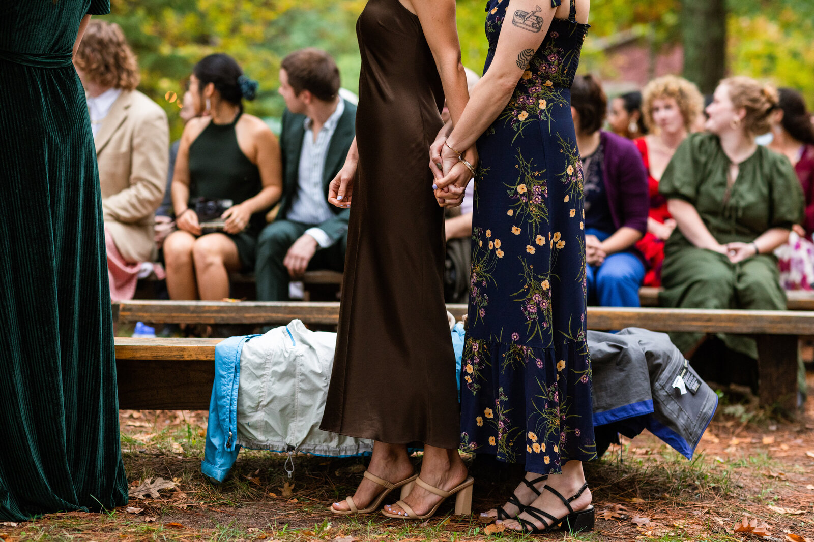 Summer Camp Wedding at camp miller. Two guests hold hands embracing for the intimate moment