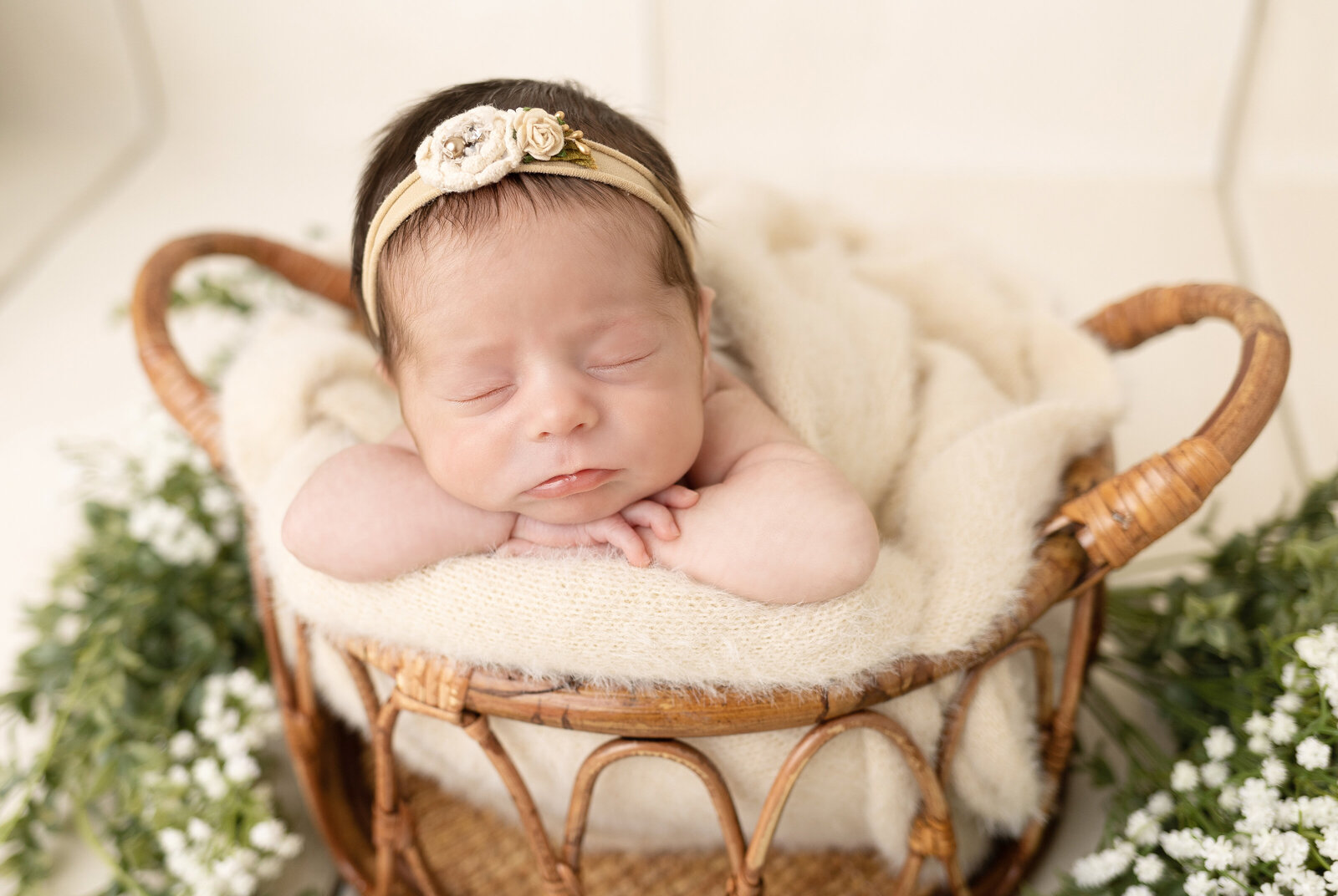 newborn baby girl in basket with florals