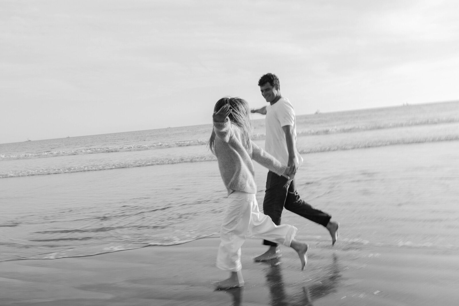 couple smiling at each other at sunset