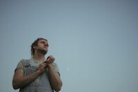 man-looking-upward-against-clear-sky