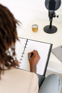 Woman Writing In Notebook