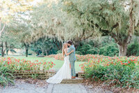 fallback shared on Invalid Date | Caledonia-a bride and groom stand hugging each other in the middle of a beautiful garden...