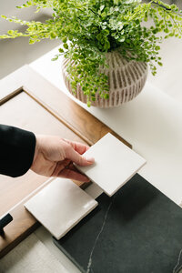 fallback shared on Invalid Date | A woman places a white tile next to a larger black tile on her desk