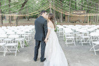 fallback shared on Invalid Date | bride and groom kissing at empty wedding venue