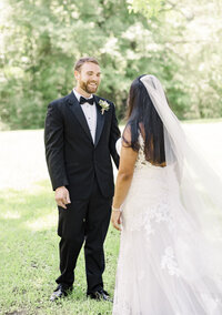 fallback shared on Invalid Date | groom smiling as he looks at bride in her dress