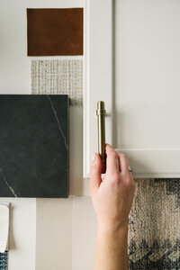 fallback shared on Invalid Date | A women places kitchen design choices on a white desk