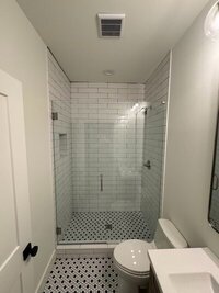 bathroom with glass shower doors and tile by renovation companies in atlanta