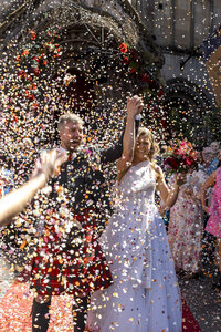 Photo of  Bride with her flower girls. Bright coloured flower bouquests.