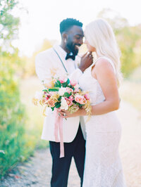 Same sex female couple embraces on wedding day