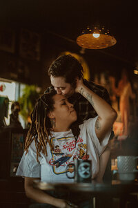 two women kiss in Mutiny Coffeeshop 