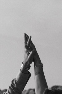 black and white photos of two hands interlocking