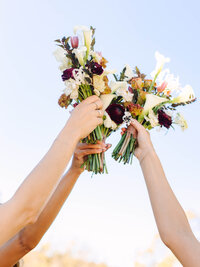 bridesmaids bouquet held up to the sky documentary photography