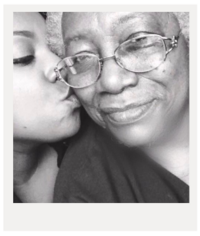 black and white image of woman kissing grandmother on the cheek