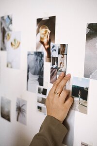 Brand styling with numerous photos on the wall, curated by Amare Creative.