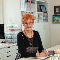 Jane Shine, sitting in her craft room