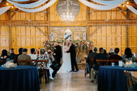 Bride and groom kissing during their wedding ceremony