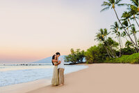 couple cuddling at sunset after their maui proposal