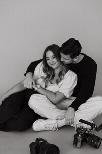 husband and wife fort myers photographers cuddling with cameras