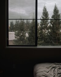 Cozy bedroom with tranquil views of pine trees in the Crowsnest Pass area