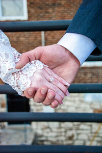 couple hold hands to show wedding ring in phoenix