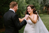 A bride and groom share a candid moment before their wedding ceremony at The Gathered in Kathryn, Alberta