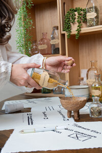 Merlyn Asencio carefully mixing herbs, embodying her holistic approach to healing and nurturing in her trauma therapy practice in Miami, Florida