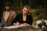 Wedding officiant smiling with newlyweds