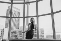 woman posing at a hotel looking out the window