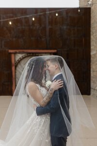 Elegant black-and-white image of a couple sharing a moment in front of a window, emphasizing the timeless nature of love and commitmen