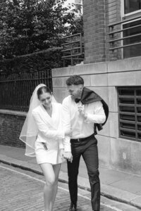 Couple embracing while walking london on thier elopement