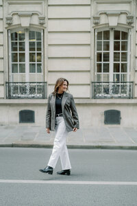 a woman walking away from the camera in paris france
