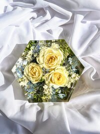 white and blue bouquet preserved in a hexagon shaped resin block