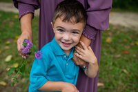 boy in blue shirt smiling up camera in berea ohio