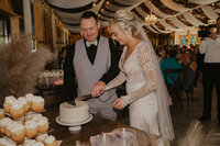 Bride and groom cutting their wedding cake