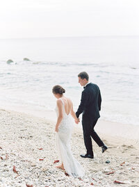 Bride and groom walking barefoot along the shore – Destination Wedding Photographer in Jamaica
