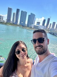Jessica Woods in front of the ocean with her husband