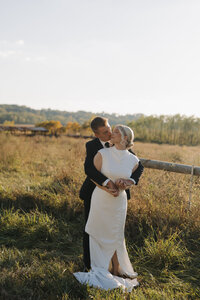 Couple running together after ceremony in black and white