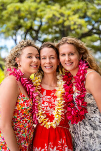 Girls wearing flower leis by family photographer in Big Island Hawaii