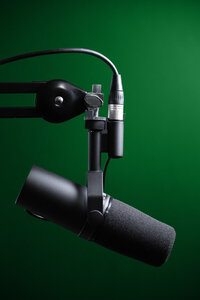 podcast mic boomed with green background
