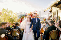 bride with umbrella walking away