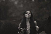 Farmer's daughter in black cowboy hat and all denim pose on an old gravel road.