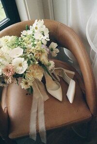 film photo of bride's heels and bouquet on chair by idaho wedding photographer erica rochelle photography