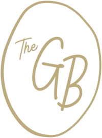a logo mark of the green bean logo cursive font
