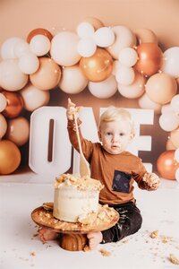 Johnny in his brown and pink themed cake smash photoshoot in auckland
