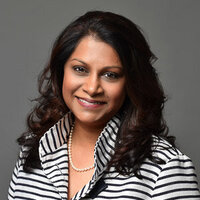 Headshot of personal wealth advisor in black and white striped jacket