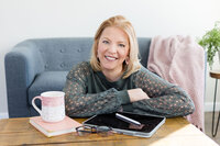 Heather wearing a pink sweater, smiling