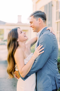 Couple embracing and laughing and engagement photoshoot
