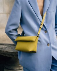 yellow bag hanging over someone's shoulder
