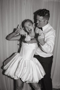 bride and groom pose for a playful post wedding ceremony picture in san diego